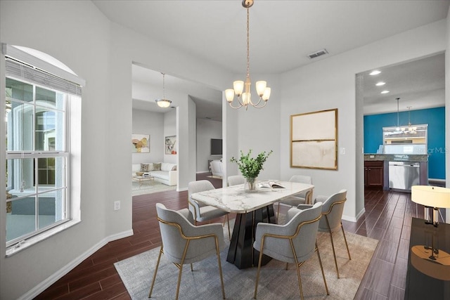 dining area with an inviting chandelier