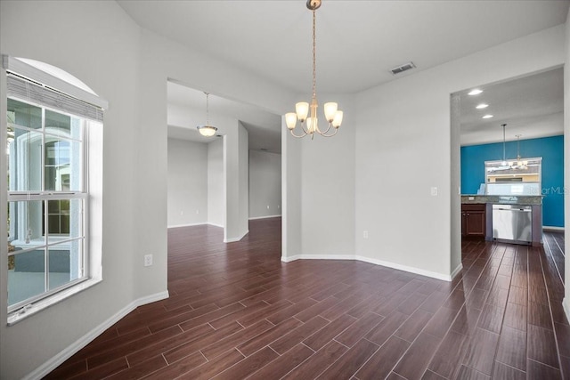 unfurnished room featuring a notable chandelier