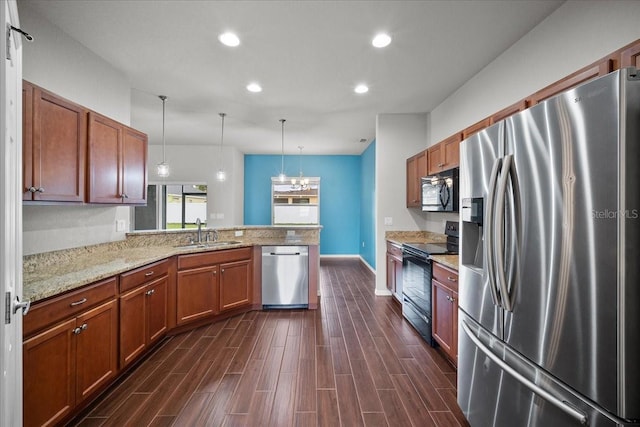 kitchen with pendant lighting, sink, light stone counters, black appliances, and kitchen peninsula