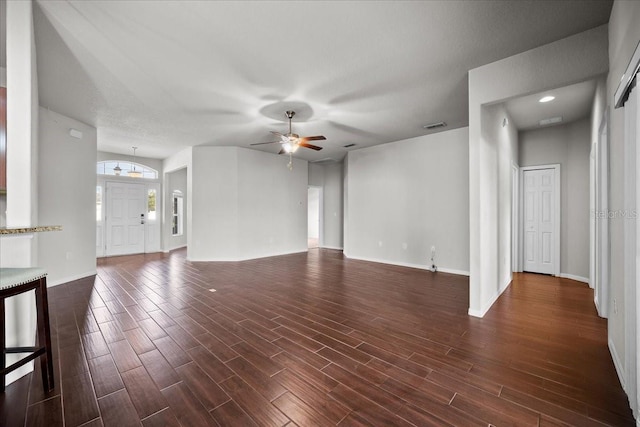 unfurnished living room with dark hardwood / wood-style floors and ceiling fan