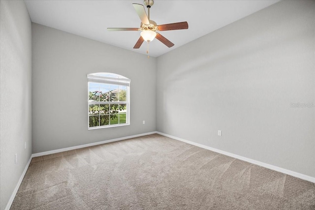 carpeted empty room featuring ceiling fan