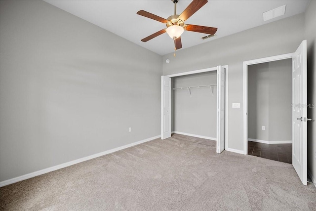 unfurnished bedroom with carpet flooring, ceiling fan, and a closet