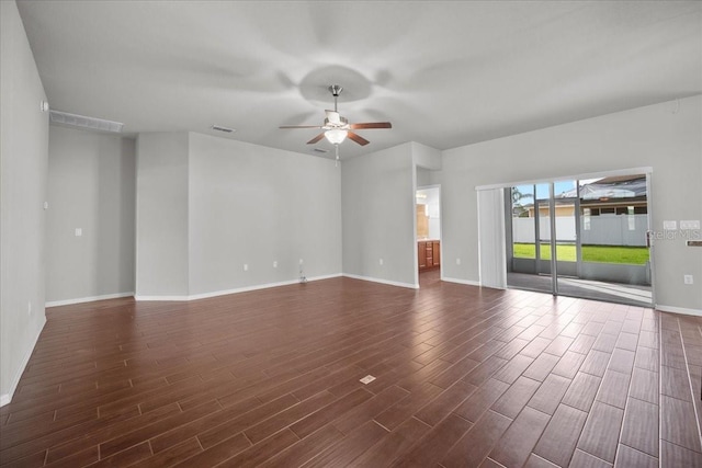 empty room with dark hardwood / wood-style floors and ceiling fan