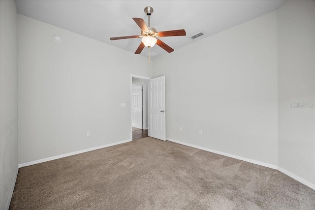 empty room featuring ceiling fan and carpet