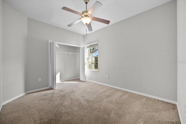 unfurnished bedroom featuring ceiling fan, a closet, and carpet