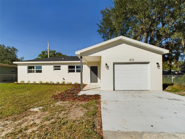 ranch-style home with a garage and a front lawn