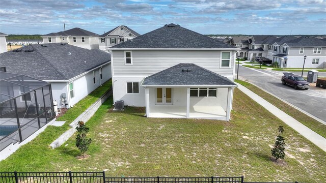 9660 Westside Hills Dr, Davenport, FL 33896 - back of property with a residential view, french doors, central air condition unit, and roof with shingles
