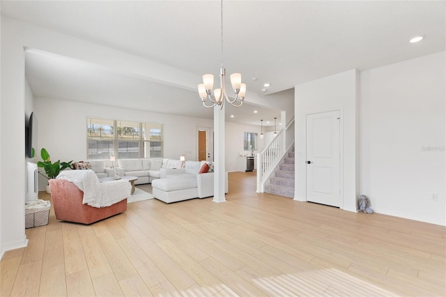 living room featuring an inviting chandelier and light wood-type flooring