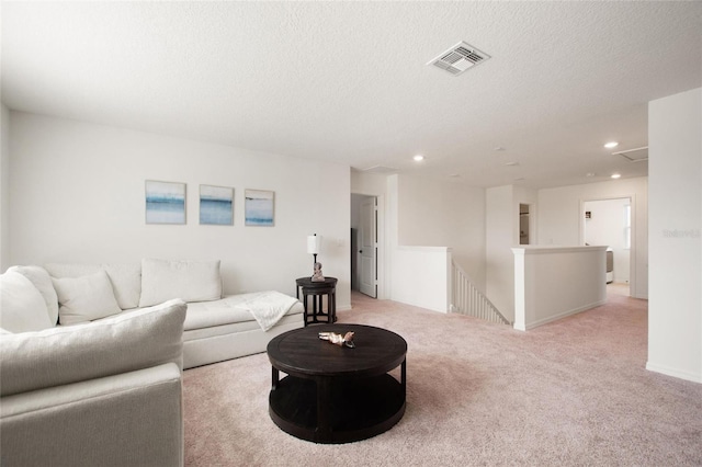 carpeted living room with a textured ceiling