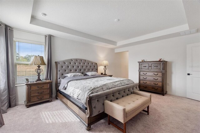 9660 Westside Hills Dr, Davenport, FL 33896 - bedroom with a tray ceiling, light carpet, a textured ceiling, and baseboards
