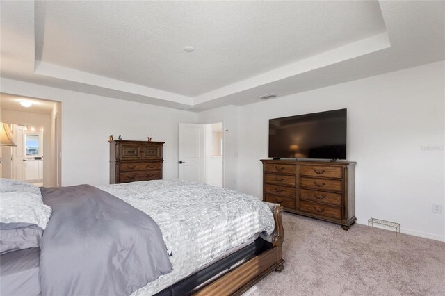 9660 Westside Hills Dr, Davenport, FL 33896 - bedroom featuring a raised ceiling, light carpet, baseboards, and ensuite bath