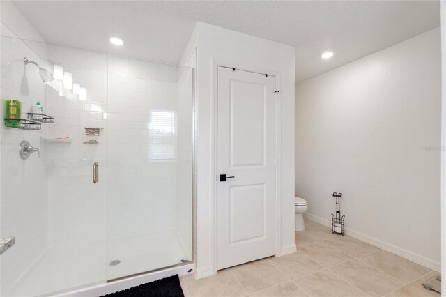 9660 Westside Hills Dr, Davenport, FL 33896 - bathroom with a shower stall, toilet, recessed lighting, tile patterned flooring, and baseboards