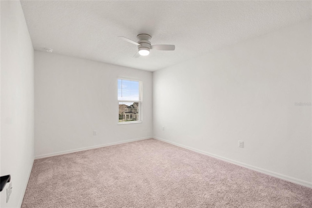 carpeted empty room with a textured ceiling and ceiling fan