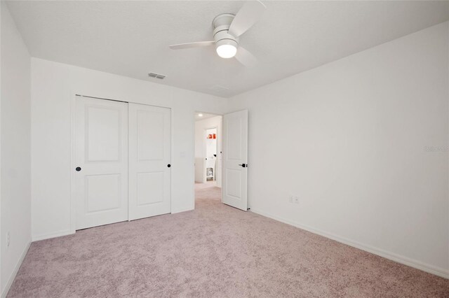 9660 Westside Hills Dr, Davenport, FL 33896 - unfurnished bedroom with carpet flooring, a closet, baseboards, and ceiling fan