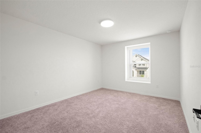 carpeted spare room with a textured ceiling