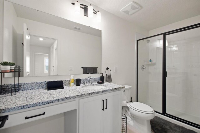 9660 Westside Hills Dr, Davenport, FL 33896 - bathroom with a shower stall, toilet, vanity, and a textured ceiling