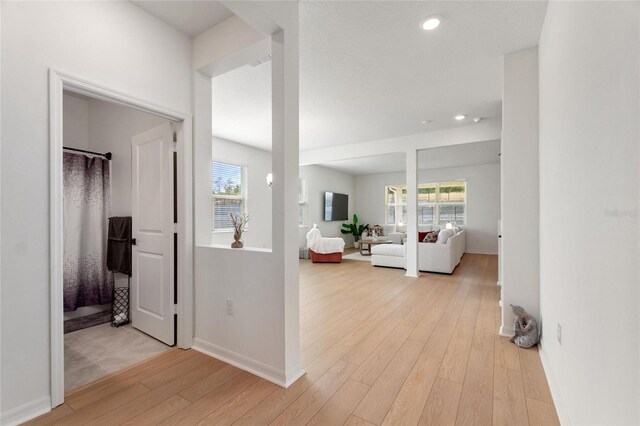 9660 Westside Hills Dr, Davenport, FL 33896 - hall with light wood finished floors, baseboards, and recessed lighting