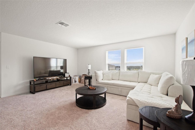 living room featuring light colored carpet and a textured ceiling