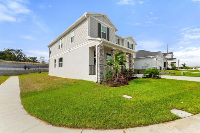 9660 Westside Hills Dr, Davenport, FL 33896 - view of home's exterior featuring covered porch, a lawn, stone siding, stucco siding, and board and batten siding