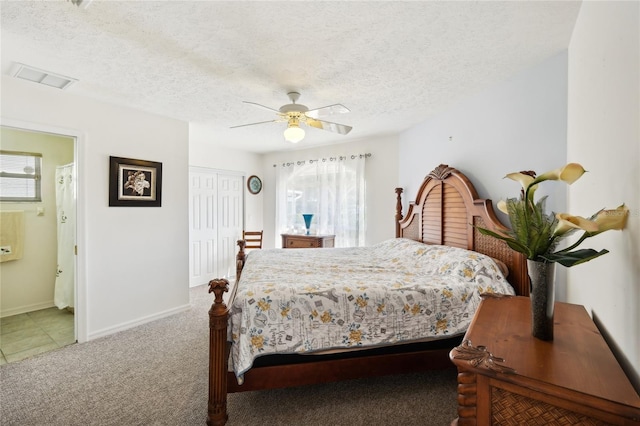 bedroom with ceiling fan, a textured ceiling, connected bathroom, and multiple windows