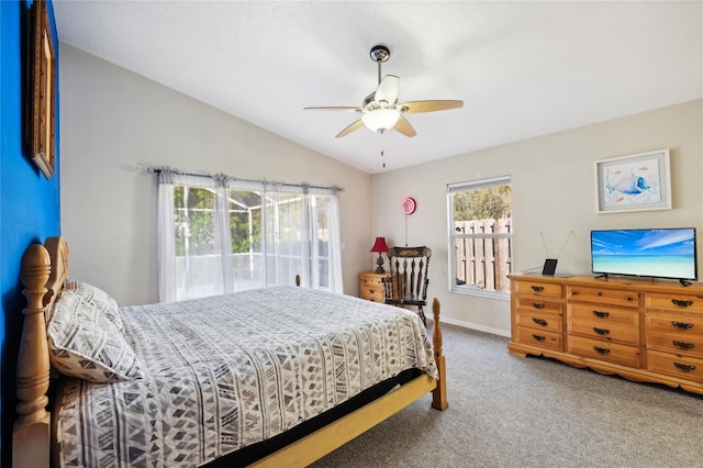 carpeted bedroom with ceiling fan and vaulted ceiling