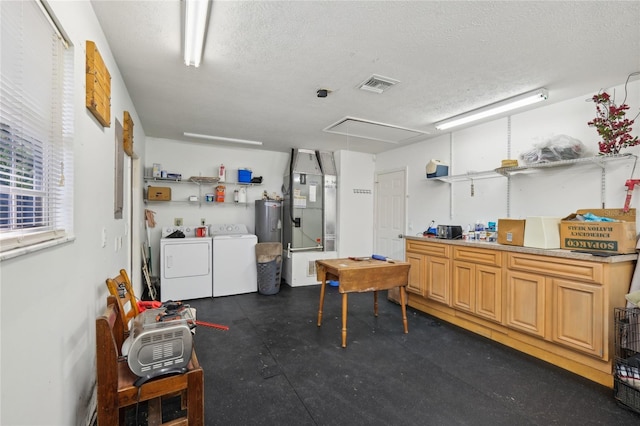 interior space with washer and dryer, a textured ceiling, and heating unit