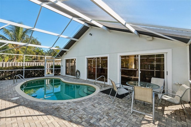 view of swimming pool with a lanai and a patio