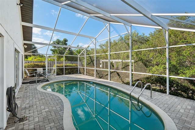 view of pool featuring a patio and glass enclosure