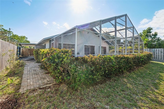 view of side of property featuring glass enclosure