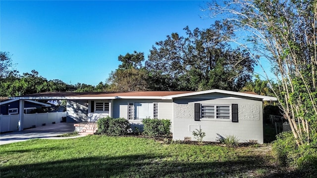 single story home with a front lawn and a carport