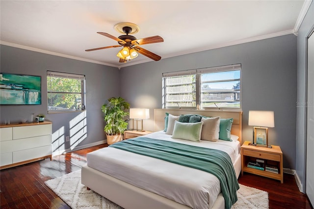 bedroom with multiple windows, wood-type flooring, ceiling fan, and crown molding