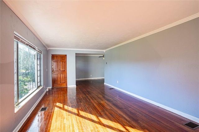 spare room with ceiling fan, ornamental molding, and dark wood-type flooring