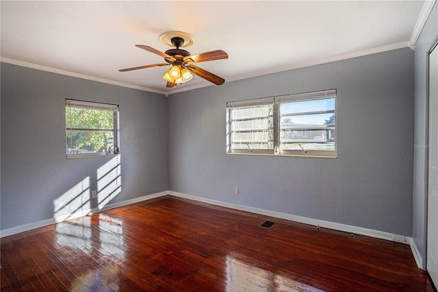 empty room featuring crown molding, hardwood / wood-style floors, and ceiling fan