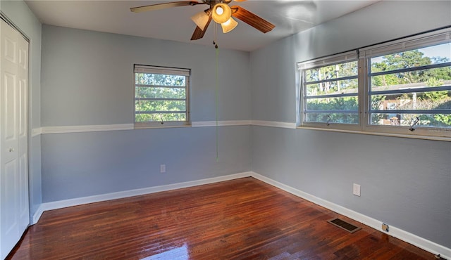 unfurnished room featuring wood-type flooring, plenty of natural light, and ceiling fan