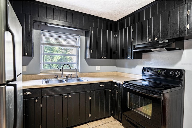 kitchen featuring stainless steel refrigerator, sink, black range with electric cooktop, a textured ceiling, and light tile patterned floors