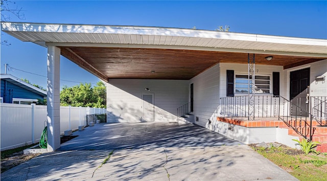 entrance to property with a carport and covered porch