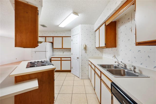 kitchen featuring dishwashing machine, a textured ceiling, electric cooktop, white fridge, and light tile patterned flooring