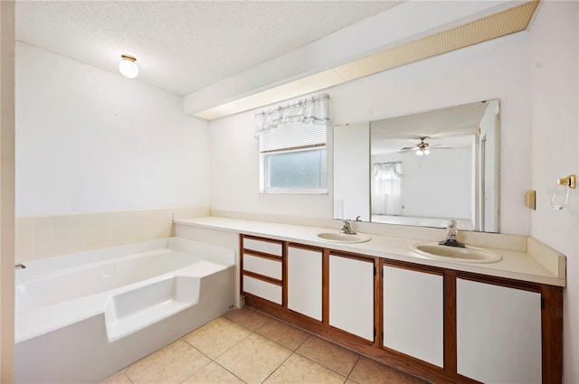 bathroom featuring vanity, tile patterned floors, a washtub, ceiling fan, and a textured ceiling