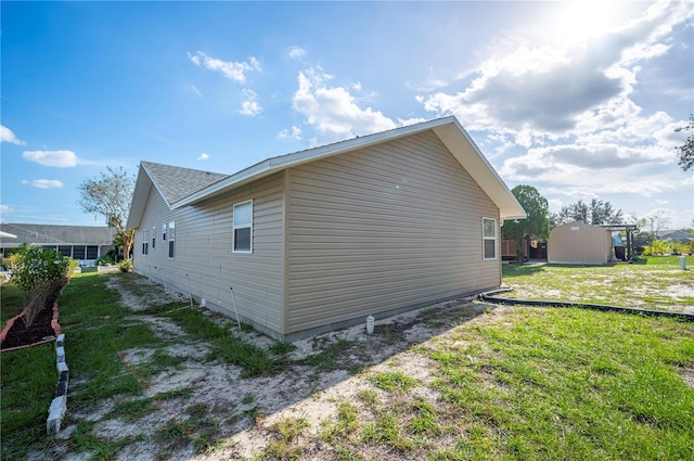 view of property exterior featuring a yard and a storage shed