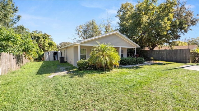 view of property exterior with a yard, central AC, and a storage unit