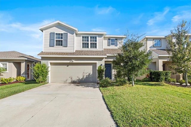 view of front of house featuring a garage and a front lawn