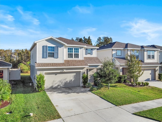 view of front of property featuring a garage and a front lawn