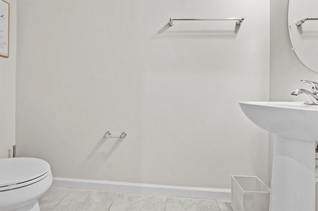 bathroom with sink, tile patterned flooring, and toilet