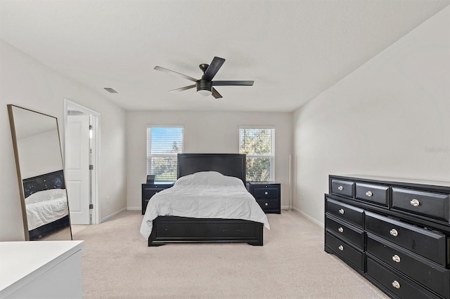 bedroom featuring light colored carpet and ceiling fan