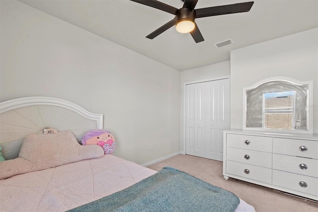 bedroom featuring light carpet, a closet, and ceiling fan