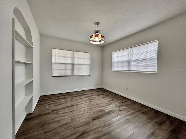 unfurnished dining area featuring dark wood-type flooring