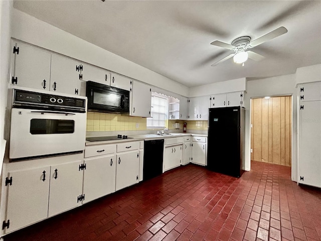 kitchen featuring ceiling fan, sink, decorative backsplash, white cabinets, and black appliances