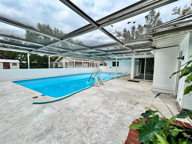 view of pool with a lanai and a patio area