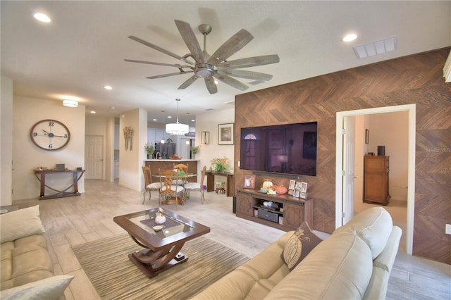 living room featuring light hardwood / wood-style floors and ceiling fan