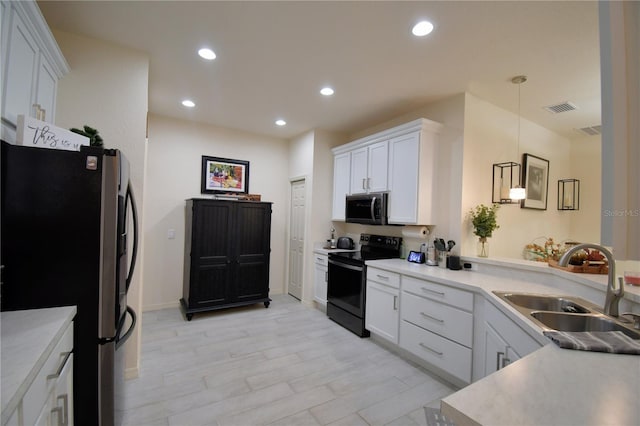 kitchen featuring pendant lighting, sink, white cabinets, and stainless steel appliances